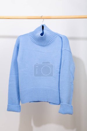 Photo for Blue wool sweater hanging on a hanger - Royalty Free Image