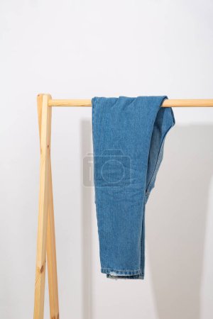 Photo for Blue denim pants on the rack - Royalty Free Image