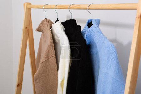 Photo for Warm wool sweaters with a stand-up collar hang on a trempel - Royalty Free Image