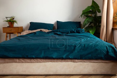 Photo for Two-color bed linen for the bed in room - Royalty Free Image