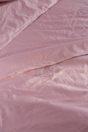 Photo for Wrinkled pink cotton bed linen blanket - Royalty Free Image