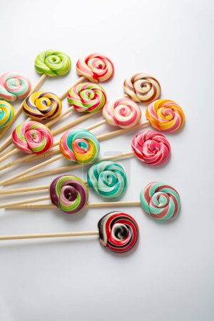 Photo for Overhead view of lollipop swirl candy food on light surface - Royalty Free Image