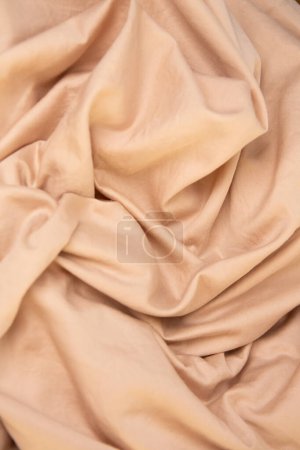 Photo for Light beige satin bed linen fabric texture - Royalty Free Image