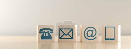 Foto de Bloques de madera con iconos de teléfono, carta, correo electrónico y símbolo de dispositivo inteligente en la mesa de madera, concepto de comunicación o contáctenos banner, ilustración 3D - Imagen libre de derechos