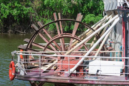 a detail of the wooden paddle steamboat on the river