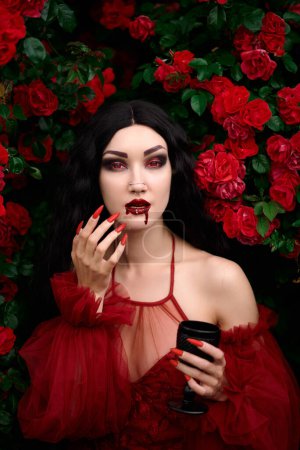 Vampire girl on a background of red roses