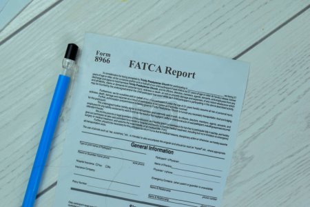 Photo for Concept of Form 8966 FATCA Report Foreign account Tax Compliance Act isolated on Wooden Table. - Royalty Free Image