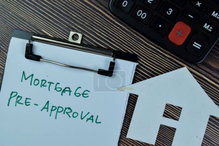 Photo for Concept of Mortgage Pre-Approval write on paperwork isolated on Wooden Table. - Royalty Free Image