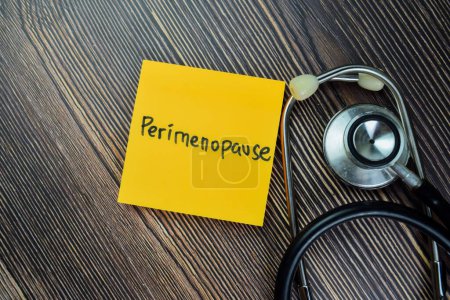 Photo for Concept of Perimenopause write on sticky notes with stethoscope isolated on Wooden Table. - Royalty Free Image