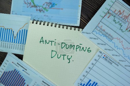 Photo for Concept of Anti-Dumping Duty write on a book isolated on Wooden Table. - Royalty Free Image