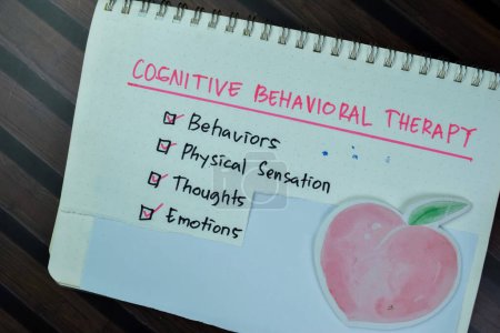 Concept of Cognitive Behavioral Therapy write on a book with keywords isolated on Wooden Table.