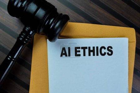 Photo for Concept of Ai Ethics text on document above from brown envelope with gavel isolated on Wooden Table. - Royalty Free Image