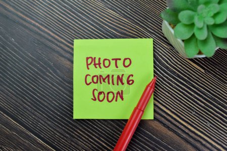 Photo for Concept of Photo Coming Soon write on sticky notes isolated on Wooden Table. - Royalty Free Image