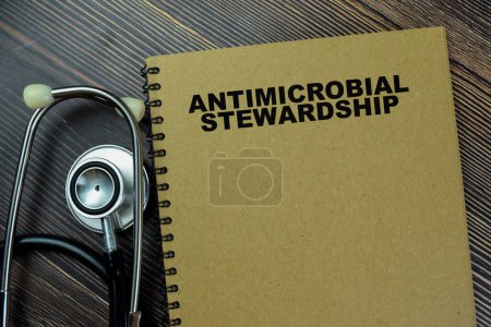 Concept of a book Antimicrobial Stewardship isolated on Wooden Table.