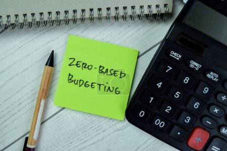 Concept of Zero-Based Budgeting write on sticky notes isolated on Wooden Table.