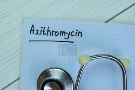 Foto de Concept of Azithromycin write on book with stethoscope isolated on Wooden Table. - Imagen libre de derechos