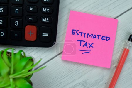 Photo for Concept of Estimated Tax write on sticky notes isolated on Wooden Table. - Royalty Free Image