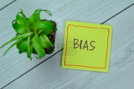Photo for Concept of Bias write on sticky notes isolated on Wooden Table. - Royalty Free Image
