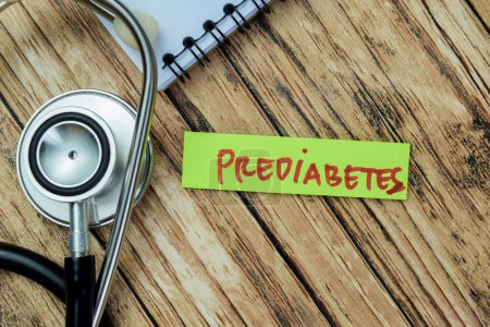 Foto de Concept of Prediabetes write on sticky notes with stethoscope isolated on Wooden Table. - Imagen libre de derechos