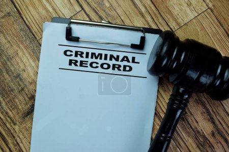 Concept of Criminal Record write on paperwork isolated on Wooden Table.