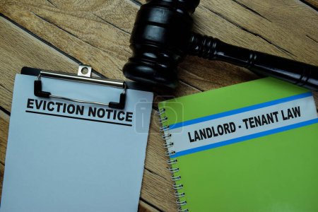 Concept of Eviction Notice write on paperwork and Landlord - Tenant Law on a book isolated on Wooden Table.