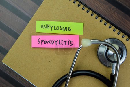 Photo for Concept of Ankylosing Spondylitis write on sticky notes isolated on Wooden Table. - Royalty Free Image