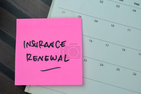 Photo for Concept of Insurance Renewal write on sticky notes isolated on Wooden Table. - Royalty Free Image