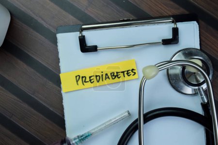 Foto de Concept of Prediabetes write on sticky notes with stethoscope isolated on Wooden Table. - Imagen libre de derechos
