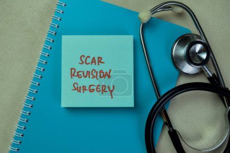 Photo for Concept of Scar Revision Surgery write on sticky notes isolated on Wooden Table. - Royalty Free Image