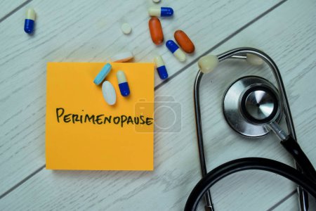 Concept of Perimenopause write on sticky notes with stethoscope isolated on Wooden Table.