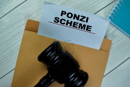 Photo for Ponzi Scheme text with document brown envelope and gavel isolated on office desk - Royalty Free Image