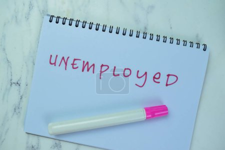 Photo for Concept of Unemployed write on book isolated on Wooden Table. - Royalty Free Image
