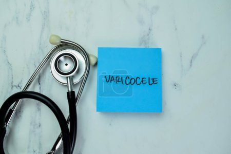 Téléchargez les photos : Concept of Varicocele write on sticky notes with stethoscope isolated on Wooden Table. - en image libre de droit