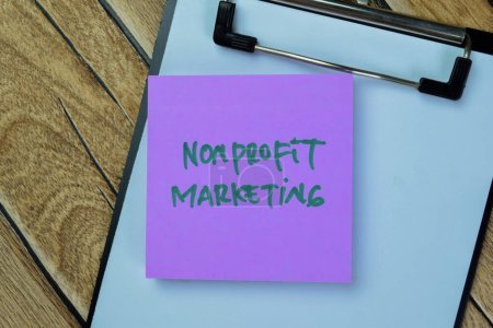 Photo for Concept of Nonprofit Marketing write on sticky notes isolated on Wooden Table. - Royalty Free Image