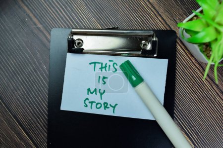 Concept of This is My Story write on sticky notes isolated on Wooden Table.