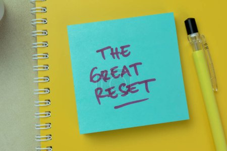 Concept of The Great Reset write on sticky notes isolated on Wooden Table.