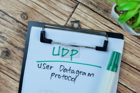 Concept of UDP - User Datagram Protocol write on paperwork isolated on Wooden Table.