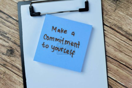 Concept of Make a Commitment To Yourself write on sticky notes isolated on Wooden Table.