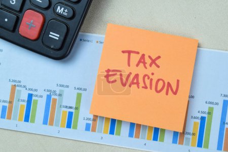 Concept of Tax Evasion write on book isolated on Wooden Table.
