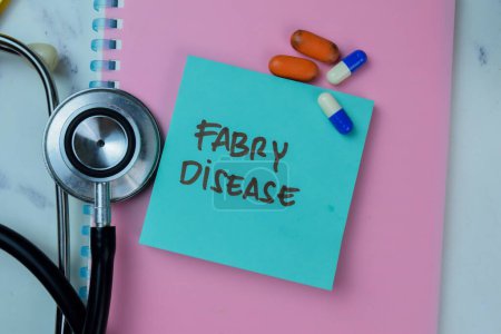 Photo for Concept of Fabry Disease write on sticky notes with stethoscope isolated on Wooden Table. - Royalty Free Image