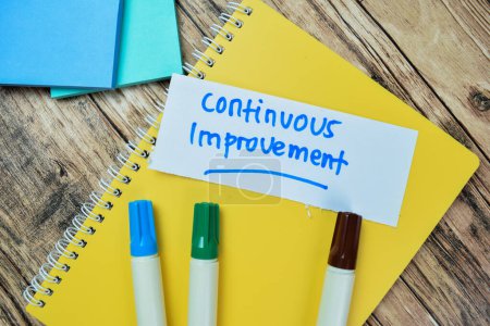 Photo for Concept of Continuous Improvement write on sticky notes isolated on Wooden Table. - Royalty Free Image