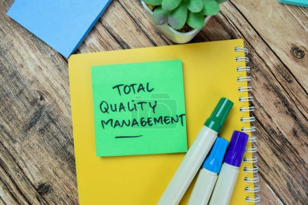 Photo for Concept of Total Quality Management write on sticky notes isolated on Wooden Table. - Royalty Free Image