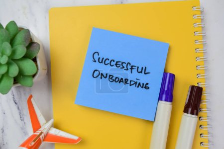 Concept of Successful Onboarding write on sticky notes isolated on Wooden Table.
