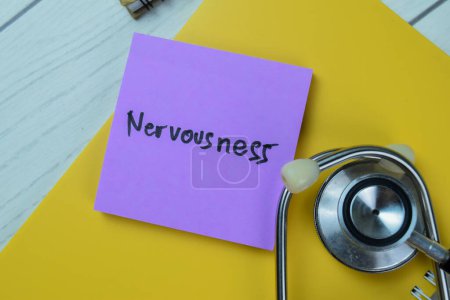 Photo for Concept of Nervousness write on sticky notes with stethoscope isolated on Wooden Table. - Royalty Free Image