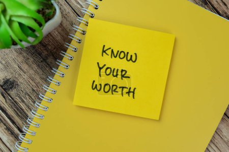Concept of Know Your Worth write on sticky notes isolated on Wooden Table.