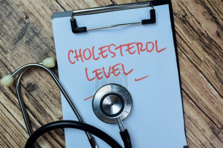 Concept of Cholesterol Level write on paperwork with stethoscope isolated on Wooden Table.