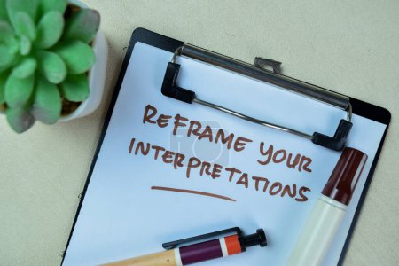 Photo for Concept of Reframe Your Interpretations write on paperwork isolated on Wooden Table. - Royalty Free Image