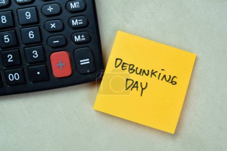 Photo for Concept of Debunking Day write on sticky notes isolated on Wooden Table. - Royalty Free Image