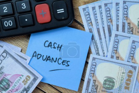 Concept of Cash Advances write on sticky notes isolated on Wooden Table.