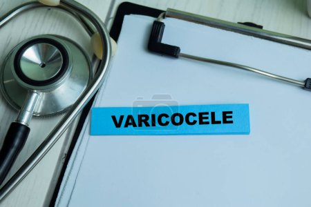 Téléchargez les photos : Concept of Varicocele write on sticky notes with stethoscope isolated on Wooden Table. - en image libre de droit